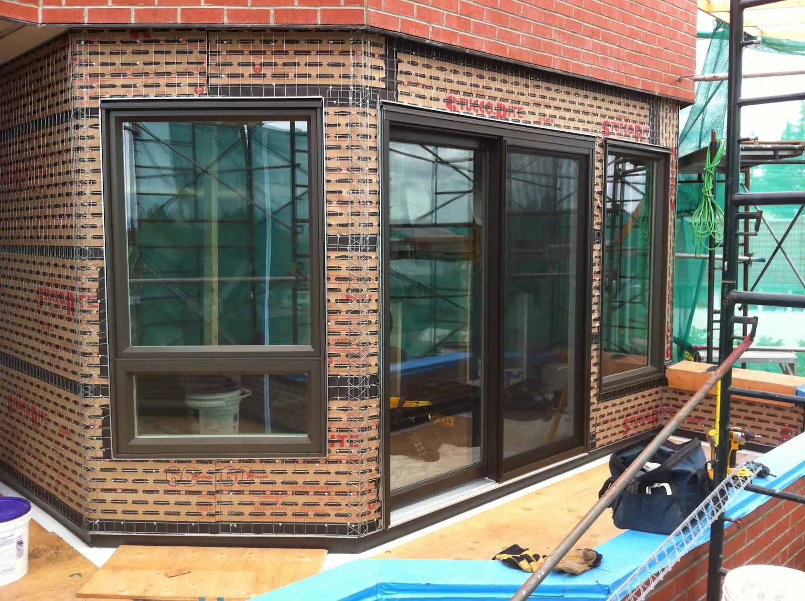 PVC window and door upgrade · New high performance custom colour pvc windows/doors prior to stucco.